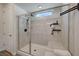 Bathroom shower with marble-style walls, a small window, and a bench at 6544 Sandero Springs St, Las Vegas, NV 89166