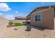 Landscaped backyard featuring a fire pit area, artificial turf, and gravel accents at 713 Webber Park St, Henderson, NV 89011