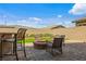 Backyard patio area offering comfortable seating around a fire pit, perfect for outdoor gatherings at 713 Webber Park St, Henderson, NV 89011