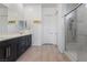 The bathroom has double sinks, a shower with a glass door, and dark cabinets at 713 Webber Park St, Henderson, NV 89011