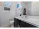 Modern bathroom featuring a sleek black vanity with a white countertop and a large mirror above the sink at 713 Webber Park St, Henderson, NV 89011