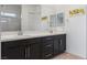 Bathroom features double sinks with dark cabinets and a framed mirror at 713 Webber Park St, Henderson, NV 89011