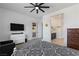 The main bedroom is spacious with a ceiling fan, a large TV, and an ensuite bathroom at 713 Webber Park St, Henderson, NV 89011
