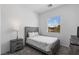 Comfortable bedroom with a large window allowing natural light; includes a bed, side table, and dresser at 713 Webber Park St, Henderson, NV 89011