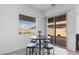 Cozy dining area with a table and stools next to a sliding door to the backyard at 713 Webber Park St, Henderson, NV 89011