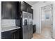 Modern kitchen boasts stainless steel appliances, dark cabinetry, and quartz countertops at 713 Webber Park St, Henderson, NV 89011
