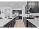Modern kitchen featuring sleek dark cabinets, stainless steel appliances, and quartz countertops at 713 Webber Park St, Henderson, NV 89011