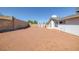 Expansive backyard featuring privacy walls, neutral desert landscaping, and a storage shed for tools at 720 Sam Jonas Dr, Las Vegas, NV 89145