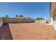 Spacious backyard featuring privacy walls, neutral desert landscaping, and a storage shed at 720 Sam Jonas Dr, Las Vegas, NV 89145