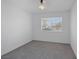 Inviting bedroom showcasing natural light, neutral carpet, and street views through the window at 720 Sam Jonas Dr, Las Vegas, NV 89145