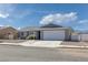 Inviting single-story home with a driveway, desert landscaping, and mountain views on a sunny day at 720 Sam Jonas Dr, Las Vegas, NV 89145