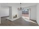 Bright living room with a stone fireplace, new floors, and backyard access at 720 Sam Jonas Dr, Las Vegas, NV 89145