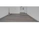 Spacious living room featuring new wood-look flooring, and bright white walls at 720 Sam Jonas Dr, Las Vegas, NV 89145