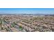Expansive aerial view of a community in the Las Vegas area with city views and mountain range at 7572 Hope Valley St, Las Vegas, NV 89139