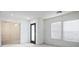 Bright, newly painted room with a view through an open doorway and natural light from a window at 7572 Hope Valley St, Las Vegas, NV 89139