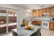 Bright eat-in kitchen with gas range, light wood cabinetry, and sliding glass doors to backyard at 7572 Hope Valley St, Las Vegas, NV 89139