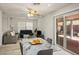 Open concept living room and breakfast nook features neutral color palette, ceiling fan, and natural light at 7572 Hope Valley St, Las Vegas, NV 89139