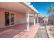 Covered brick patio with white pergola, ideal for outdoor relaxation and entertaining, with sliding door at 7572 Hope Valley St, Las Vegas, NV 89139