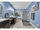 Well-lit bathroom with double sinks, updated shower, and modern design at 781 Wigan Pier Dr, Henderson, NV 89002