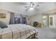 Inviting bedroom with a ceiling fan, natural light, and a neutral color palette at 781 Wigan Pier Dr, Henderson, NV 89002