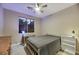 Cozy bedroom featuring a ceiling fan, a comfortable bed, and a functional desk area by the window at 781 Wigan Pier Dr, Henderson, NV 89002