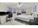 Inviting bedroom featuring a comfortable bed, a desk with computer setup, and scenic outside views at 781 Wigan Pier Dr, Henderson, NV 89002