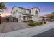 Attractive two-story home featuring a brick-paved driveway, a two-car garage, and manicured landscaping at 781 Wigan Pier Dr, Henderson, NV 89002