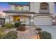 Desirable two-story home featuring an arched entryway, a two-car garage, and drought-tolerant landscaping at 781 Wigan Pier Dr, Henderson, NV 89002