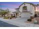 Attractive two-story home featuring well-maintained landscaping, a two-car garage, and desert-friendly yard at 781 Wigan Pier Dr, Henderson, NV 89002