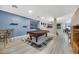 Open concept game room with billiard table, wood-look floors, and view to the Gathering room at 781 Wigan Pier Dr, Henderson, NV 89002