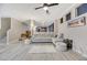 Open Gathering room with stone fireplace, light gray sofa, and view to stairs at 781 Wigan Pier Dr, Henderson, NV 89002