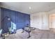 Large exercise room featuring workout equipment and a modern navy accent wall at 7920 Pandora Sky St # 281, North Las Vegas, NV 89084