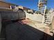 Unfinished backyard area featuring cinder block retaining wall and spiral staircase at 8049 Celestial Ave # 201, Las Vegas, NV 89128