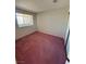 Bedroom showcasing a window with bars and neutral walls providing natural light at 8049 Celestial Ave # 201, Las Vegas, NV 89128