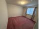 Bedroom with a window covered in patterned curtains and red carpeting at 8049 Celestial Ave # 201, Las Vegas, NV 89128
