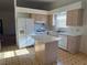 Bright eat-in kitchen with a center island, white appliances, and natural wood cabinets at 8049 Celestial Ave # 201, Las Vegas, NV 89128