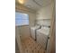 Laundry room with a washer, dryer, and a window for natural light at 8049 Celestial Ave # 201, Las Vegas, NV 89128