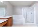 A bathroom with a soaking tub and shower with glass doors at 8174 Amphora St, Las Vegas, NV 89139
