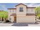 Inviting two-story home featuring a tile roof, neutral stucco exterior, and an attached two-car garage at 8174 Amphora St, Las Vegas, NV 89139