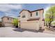 Two-story home featuring a large garage, stucco siding, and a tile roof in a suburban setting at 8174 Amphora St, Las Vegas, NV 89139