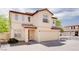 Inviting two-story home featuring a tile roof, neutral stucco exterior, and an attached two-car garage at 8174 Amphora St, Las Vegas, NV 89139