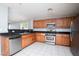 Well-equipped kitchen featuring stainless steel appliances, dark countertops, and tile flooring at 8174 Amphora St, Las Vegas, NV 89139