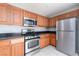 Functional kitchen featuring stainless steel appliances, wooden cabinets, and tile flooring at 8174 Amphora St, Las Vegas, NV 89139