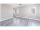 Spacious living room with plenty of natural light and stylish gray wood-look flooring at 8174 Amphora St, Las Vegas, NV 89139