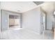 Bright living room with tile flooring, neutral paint, and a sliding glass door leading to the backyard at 8174 Amphora St, Las Vegas, NV 89139