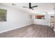 Bright living room with hardwood floors, large windows, and an open view to the kitchen at 8174 Amphora St, Las Vegas, NV 89139