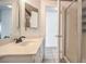 Bathroom featuring a framed mirror, a white vanity, and a glass-enclosed shower, all in a neutral color palette at 8308 Tide Pool Dr, Las Vegas, NV 89128