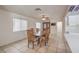 Traditional dining room with a wooden table and chairs, plus a ceiling fan and tiled flooring at 8308 Tide Pool Dr, Las Vegas, NV 89128
