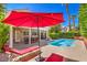Beautiful backyard with a sparkling pool, lounge chairs, and a covered patio at 8308 Tide Pool Dr, Las Vegas, NV 89128