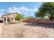 Large backyard includes an extended brick perimeter, seating area, and shade trees at 8345 Spruce Meadows Ave, Las Vegas, NV 89131